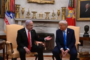 Israeli Prime Minister Netanyahu gestures while speaking with U.S. President Trump during their White House meeting, discussing Gaza and Middle East policy.